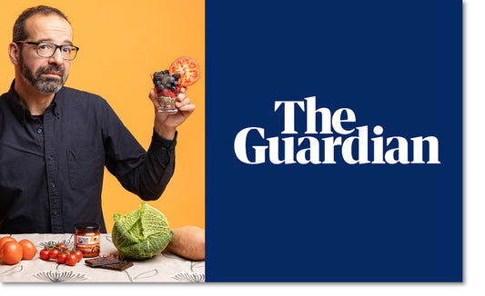 Man holding up a glass of fruit with The Guardian written in bold text next to him