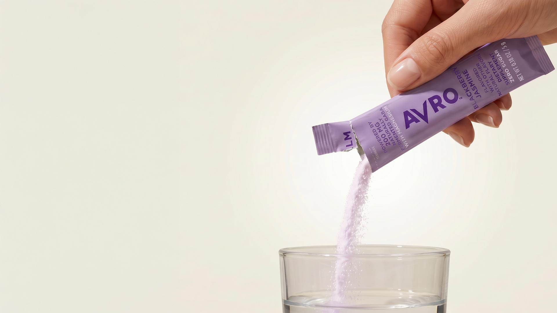 Pouring an AVRO Calm stick into a glass of water